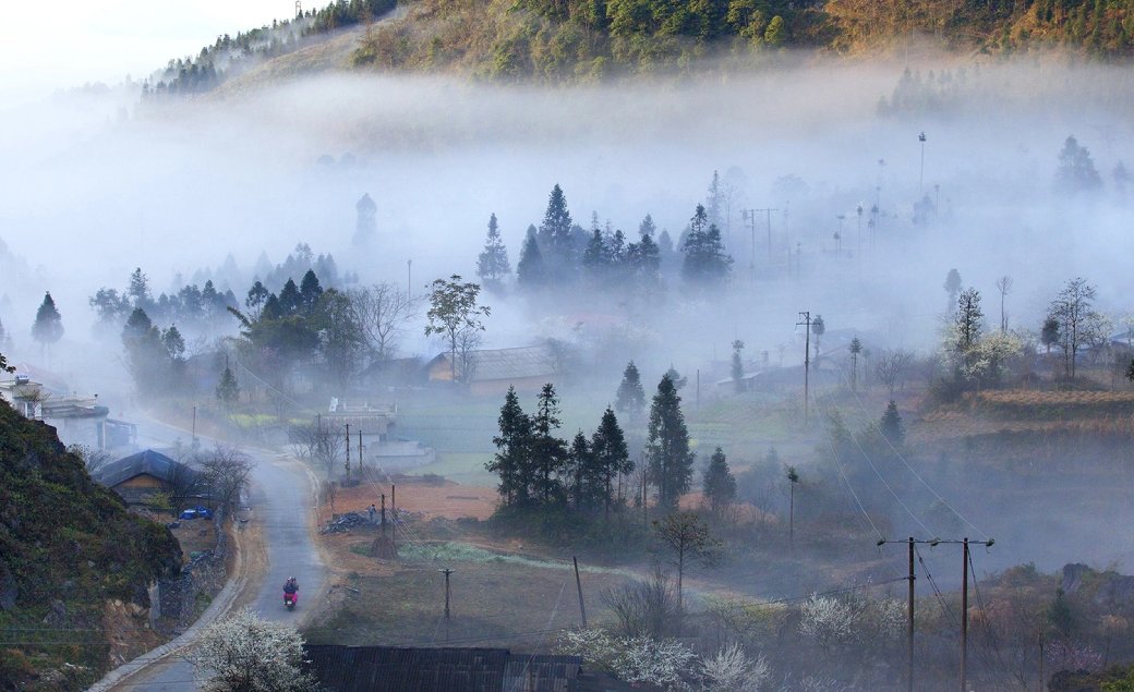 Dreamy morning fog over a highland ethnic village in Ha Giang in November